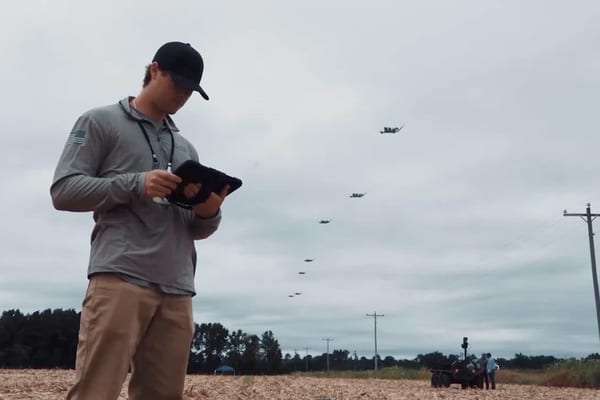 Drone on landing pad with controller, illustrative image